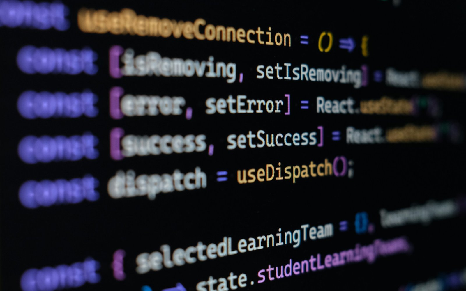 Engineer looking at computer screen and writing code.